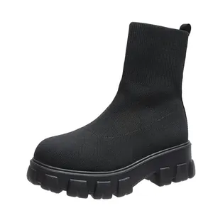 Side view detail of black knitted sock boots with thick chunky lug sole for women