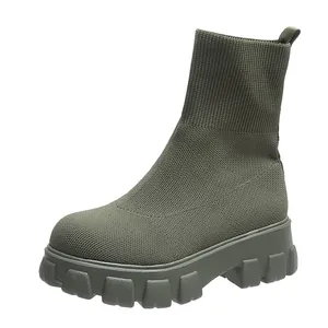 Detailed side view of an olive green knit sock boot with a chunky platform lug sole.