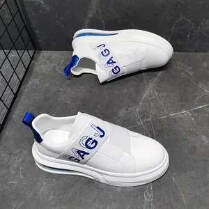 Detailed side view of white men's sneakers featuring blue GAGJ logo and elastic strap.