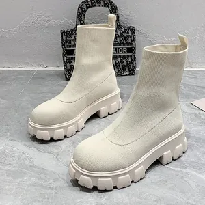 Detail view of cream fly-knit sock boots with a trendy chunky platform lug sole