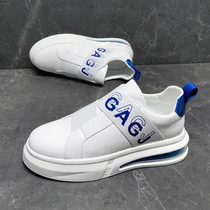 Detailed view of white men's slip-on sneakers featuring a blue elastic strap design