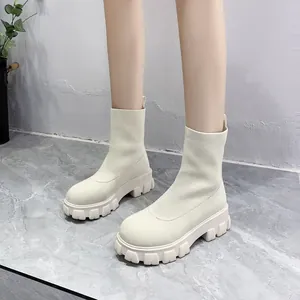 Macro view of cream knitted sock boots featuring thick anti-slip platform soles for women
