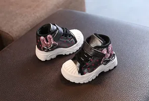 Detail view of warm winter children's boots with glitter bunny ears decoration