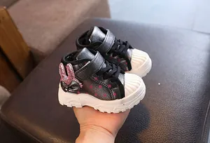Detailed view of children's warm winter snow boots featuring glittery pink rabbit ears