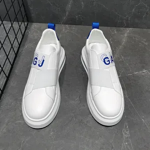 Detailed view of white men's slip-on sneakers with blue elastic strap accents