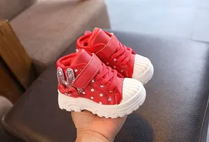 Red polka dot children's winter snow boots with warm fleece lining and bow detail