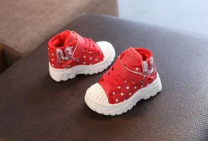 Close-up view of red winter boots for girls with warm fur lining and rabbit ear details