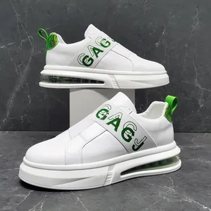 Detailed side view of white men's slip-on sneakers featuring a green elastic GAGJ strap