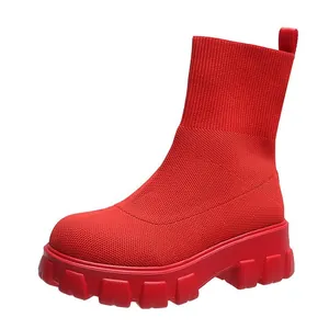 Vibrant red fly-knit sock boots with chunky platform sole and high-top knitted design