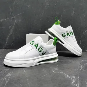 Side detail view of stylish white men's casual sneakers with green accents and air cushion