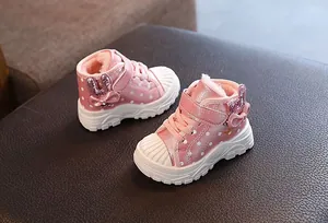 Detail view of pink plush-lined winter boots for girls with cute bunny ear accents