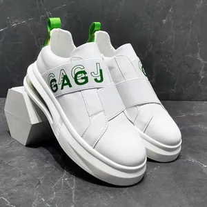 Detailed macro view of white slip-on men's casual sneakers with green GAGJ logo band
