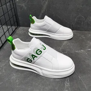 Close-up of trendy white men's slip-on sneakers with green elastic band detail