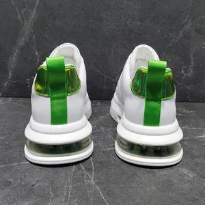 Back view of white men's sneakers with neon green pull tabs and air cushion sole