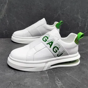 Detailed side view of trendy white men's slip-on sneakers with green air cushion sole