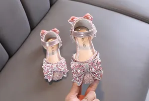 Detailed view of pink princess shoes with sparkling rhinestones and pearls