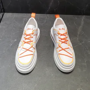 Vista superior detallada de zapatillas blancas para hombre con cordones naranja vibrantes