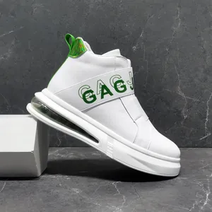 Side view of white men's sneaker with green GAGJ text and air cushion
