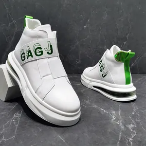 Close-up of white men's high-top sneakers with green accents and air cushion sole