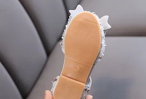Close-up of the non-slip rubber sole on a girl's princess dance shoe with size 26 mark