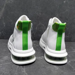 Detail of white men's high-top sneakers with green heel accents and air cushion.