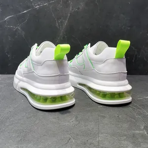 Detalle de zapatillas blancas con acentos verde neón y suelas de cámara de aire transparente