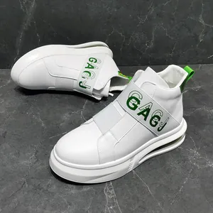 Close-up view of stylish white high-top men's sneakers with green GAGJ strap accents