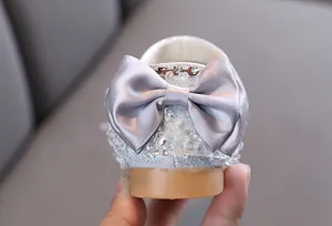 Close-up detail showing the grey satin bow on silver girls crystal princess shoes