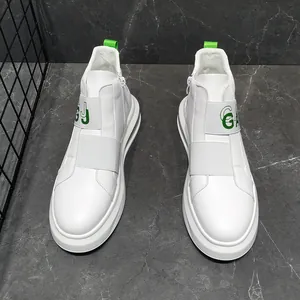 Macro detail view of white casual men's high-top sneakers with green letter straps.