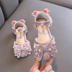 Sparkling pink girls princess shoes featuring a large rhinestone bow and pearl accents