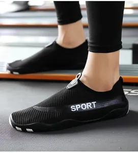Detail view of black breathable water shoes with SPORT logo on a treadmill background.