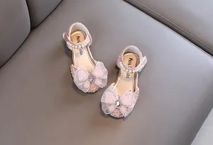 Elegant pink princess shoes for girls with lace bow, pearl, and rhinestone details