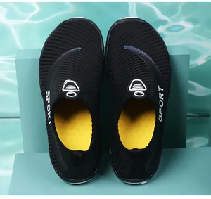 Top-down detail of black mesh water shoes with yellow insoles for yoga and beach activities