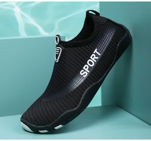 Close-up detail of breathable black water shoes with "SPORT" logo on side for beach and swimming.
