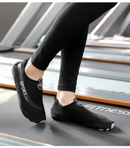 Close-up of black breathable yoga fitness shoes for couples on a fitness treadmill