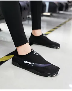Detail of black aqua shoes with SPORT lettering and purple accent for fitness.