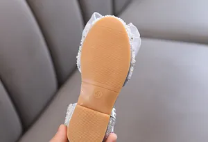 Close-up view of a girl's sparkling princess shoe sole featuring size 26 marking