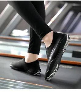 Detail view of black breathable yoga fitness shoes with non-slip sole on a gym treadmill