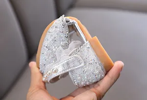 Detail showing the soft, flexible sole of silver glitter princess shoes for girls