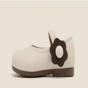 Elegant beige toddler girl Mary Jane shoes with brown flower detail and soft rubber sole