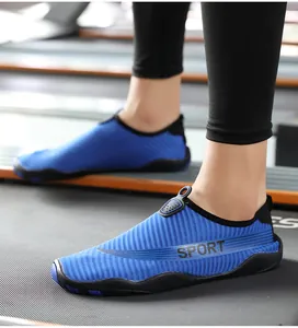 Close-up detail view of blue breathable fitness water shoes worn on a gym treadmill