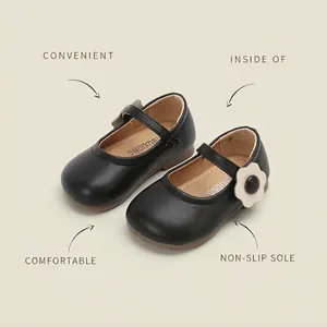 Toddler girls black leather Mary Jane shoes with flower detail and velcro closure.