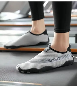 Detail view of breathable striped fitness and water shoes worn by a model on a treadmill