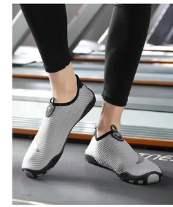 Close-up view of gray striped breathable lightweight water shoes being used on a treadmill