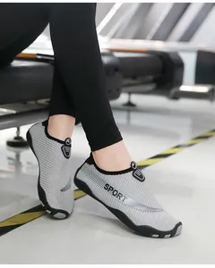 Close-up view of lightweight grey striped water shoes worn for yoga and beach fitness