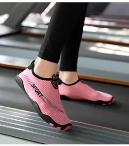 Close-up view of pink striped barefoot fitness shoes being used on a gym treadmill