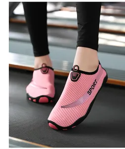 Close-up of pink breathable water shoes with soft non-slip soles for yoga and fitness.