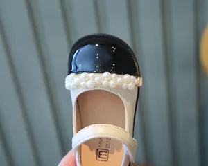 Detailansicht der Mädchen-Mary-Janes in Creme mit eleganten Perlenverzierungen