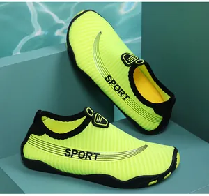 Detailed view of bright yellow breathable aqua shoes for swimming and beach sports.