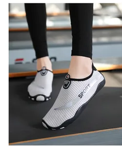 Close-up of breathable grey water shoes with 'SPORT' text and slip-resistant sole